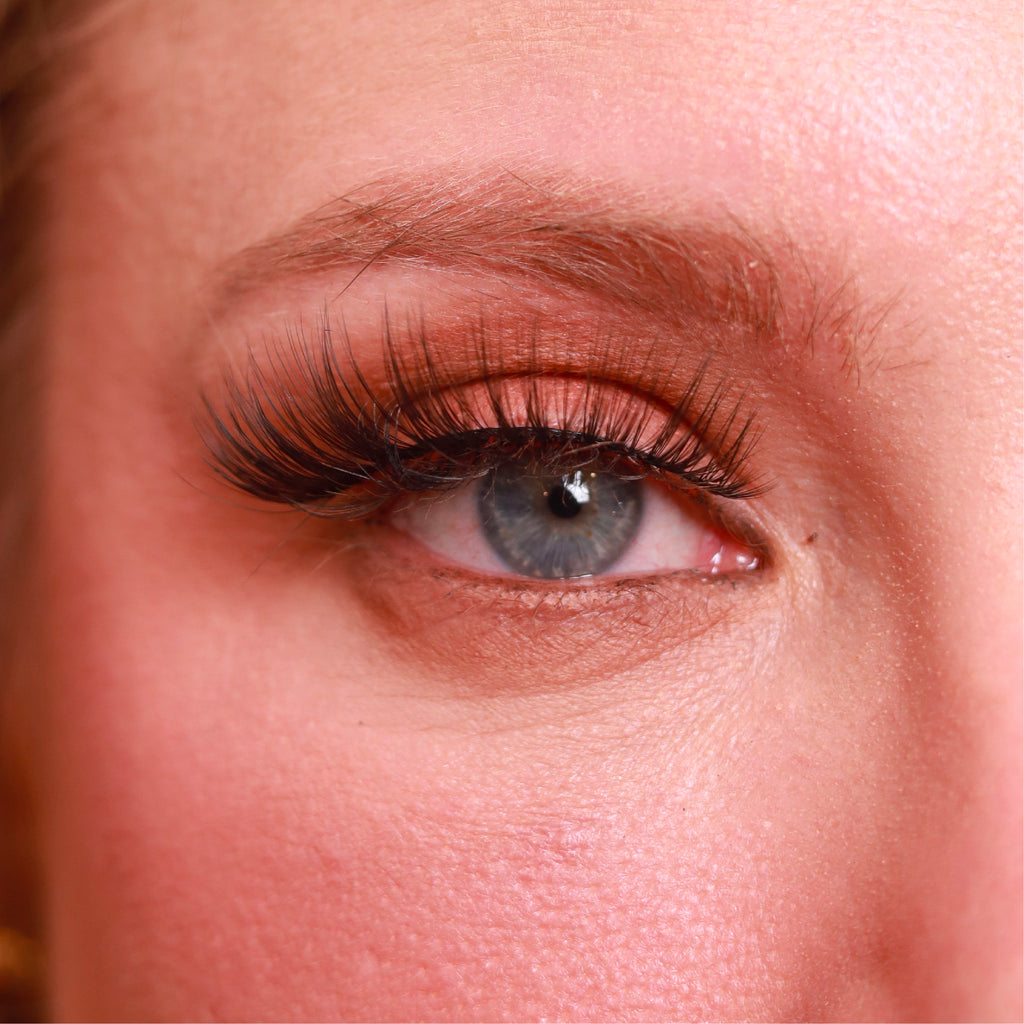 closeup of eye of caucasian woman wearing best fake eyelash extensions highkey cute cruelty free vegan false eyelashes | lulu lashes