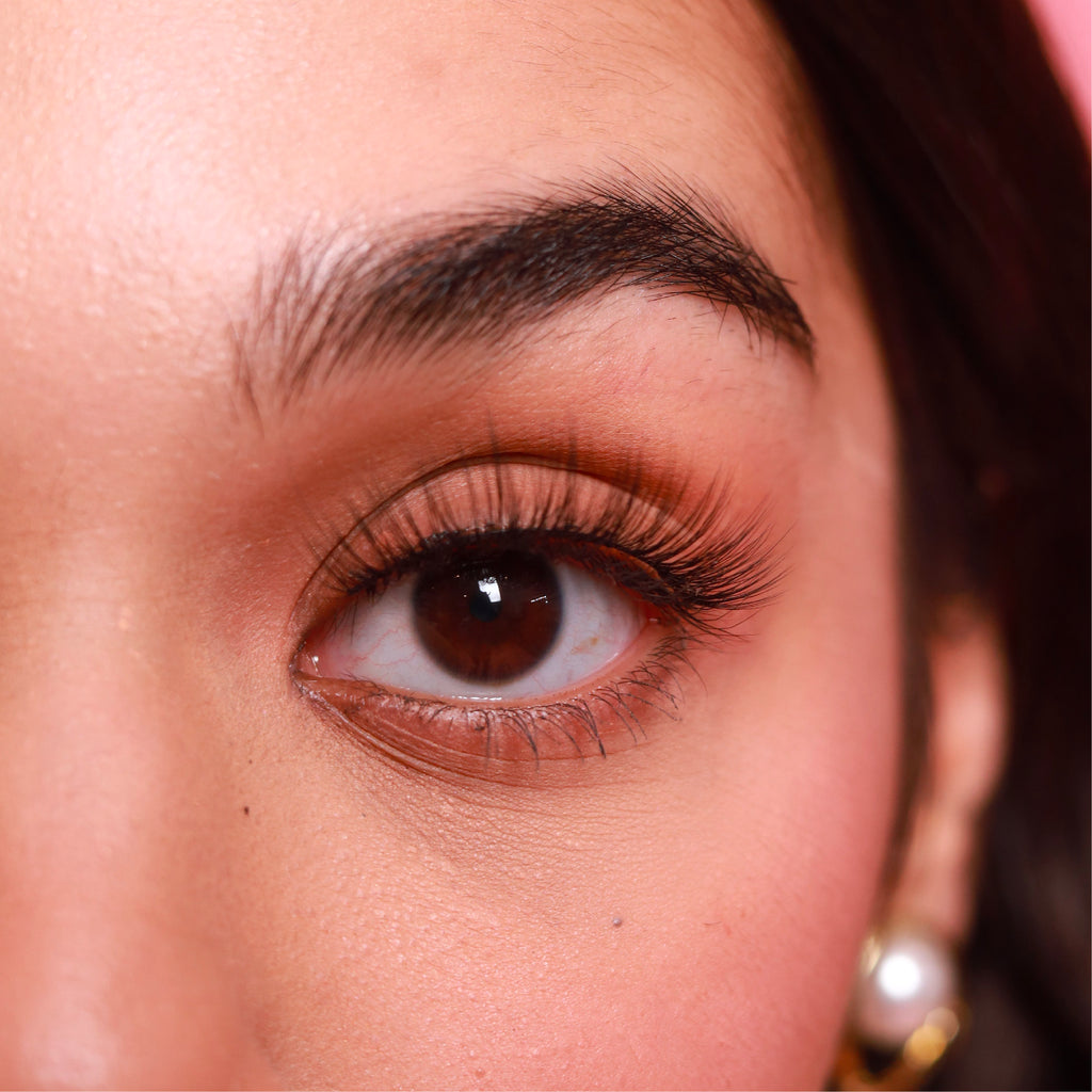 closeup of eye of brown woman wearing best fake eyelash extensions clearly hot cruelty free vegan false eyelashes | lulu lashes